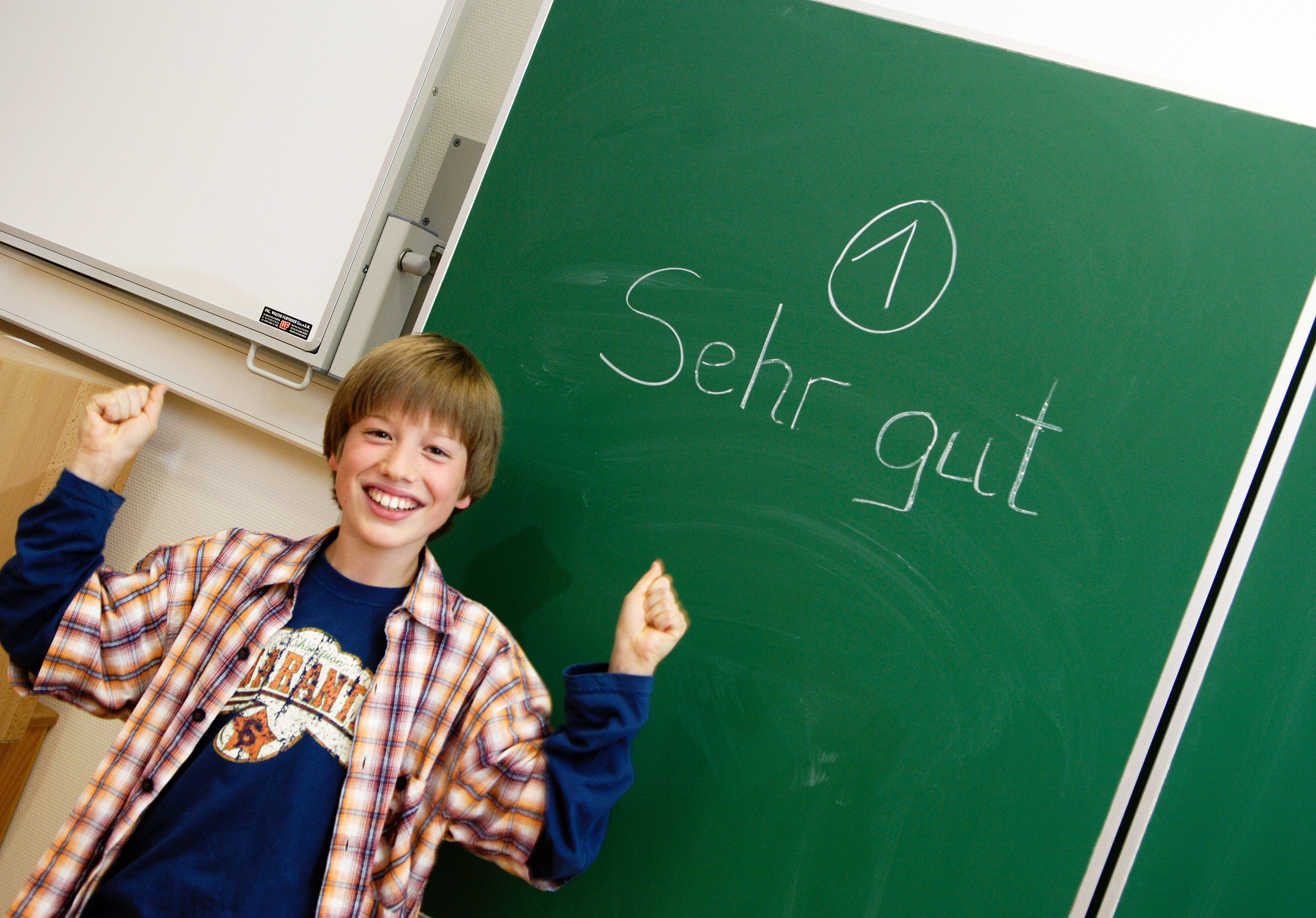 Учеба важнее. A boy standing at the blackboard.